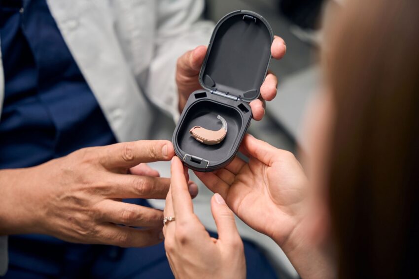 man holding hearing aid